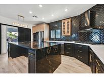 Modern kitchen features granite counters, stainless appliances, and custom cabinets at 3738 Falcon Springs Dr, Las Vegas, NV 89147