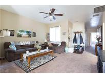 Cozy living room with a ceiling fan, neutral paint, and comfortable seating arrangement at 4625 Centisimo Dr # 202, North Las Vegas, NV 89084