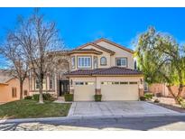 Two-story house with beige exterior, two-car garage, and landscaping at 5423 San Florentine Ave, Las Vegas, NV 89141
