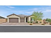 Single-story house with two-car garage, landscaping, and a neutral color scheme at 6160 Lautman Ridge Ct, Las Vegas, NV 89141