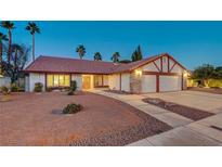 Brick house with a two-car garage and a landscaped front yard at 6466 Scotch Pine Cir, Las Vegas, NV 89146