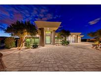 Modern luxury home with stunning nighttime curb appeal at 686 Tranquil Rim Ct, Henderson, NV 89012