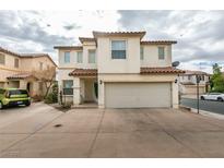 Two-story house with attached garage and landscaping at 9100 Spoonbill Ridge Pl, Las Vegas, NV 89143