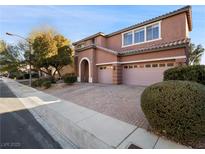 Two-story house with a three-car garage and landscaped front yard at 9632 Staff Ln, Las Vegas, NV 89178