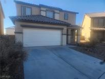 Two-story house with attached garage and desert landscaping at 3513 Kendall Point Ave, North Las Vegas, NV 89081