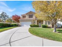 Two-story house with a curved driveway and landscaping at 4895 Berino Dr, Las Vegas, NV 89147
