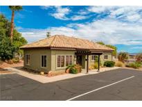 Building exterior featuring Spanish-style tile roof and ample parking at 799 Bluebird Dr, Boulder City, NV 89005