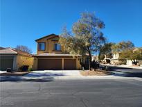 Two-story house with brown double garage and landscaping at 9853 Red Deer St, Las Vegas, NV 89143