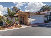 Spanish style home with attached garage and gated entry at 2011 Plaza De Cielo, Las Vegas, NV 89102