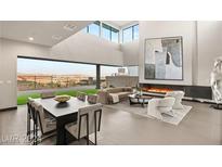 Spacious living room with floor to ceiling windows and fireplace at 36 Rainbow Point Pl, Henderson, NV 89011