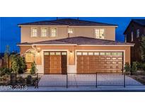 Two-story house with brown double doors and a metal fence at 917 Old Creek Way, North Las Vegas, NV 89084