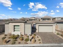 Single-story home with stone accents and a two-car garage at 949 Twinflower Peak Ct, Las Vegas, NV 89138