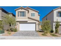 Two-story house with white garage door and landscaping at 10122 Ashford Mill Ct, Las Vegas, NV 89178