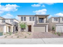 Two-story house with balcony, attached garage, and landscaped front yard at 10224 Eden Mountain St, Las Vegas, NV 89141