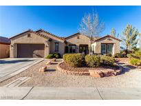 Single-story home with landscaped front yard, attached garage, and desert landscaping at 2159 Clearwater Lake Dr, Henderson, NV 89044