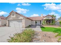 Charming single-story home featuring a two-car garage, stucco exterior, and desert landscaping for low maintenance at 2829 Forrest Duke Ct, Las Vegas, NV 89108