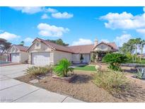 Charming single-story home with a well-maintained, desert-landscaped front yard and a two-car garage at 2829 Forrest Duke Ct, Las Vegas, NV 89108