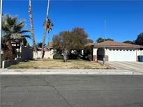 Charming single-story home with well-maintained lawn, mature trees, and an attached two-car garage at 3034 Chapala, Las Vegas, NV 89120
