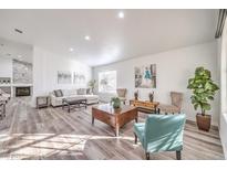 Bright living room features hardwood floors, comfy seating, and large windows at 1046 Weatherboard St, Henderson, NV 89011