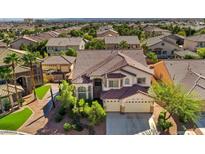 Two-story house with tile roof, three-car garage, and landscaped yard in a residential neighborhood at 10534 Torre De Nolte St, Las Vegas, NV 89141