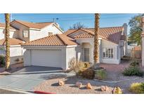 Charming single-story home featuring a tile roof, attached garage, and desert landscaping at 1612 Indian Cove Ln, Las Vegas, NV 89128