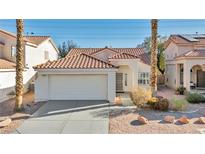 One-story house with attached garage and desert landscaping at 1612 Indian Cove Ln, Las Vegas, NV 89128