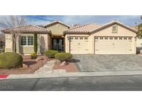 Beautiful single-story home with a three-car garage and well-manicured landscaping at 2624 Torch Ave, North Las Vegas, NV 89081