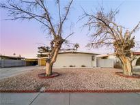 Ranch style home with mature trees and gravel landscaping at 2736 Taylor Ave, North Las Vegas, NV 89030