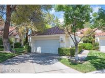 Well-maintained single-story home with attached garage and landscaped yard at 6970 Emerald Springs Ln, Las Vegas, NV 89113