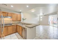 Modern kitchen with stainless steel appliances and light wood cabinets at 91 E Agate Ave # 401, Las Vegas, NV 89123