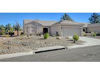 Single-story house with a two-car garage and well-manicured landscaping at 1474 Fieldbrook St, Henderson, NV 89052