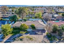Aerial view of single-story house with landscaped yard and driveway at 3699 Mountcrest Dr, Las Vegas, NV 89121