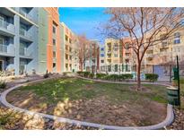 Community features a grassy courtyard, pool, and modern building at 38 E Serene Ave # 416, Las Vegas, NV 89123