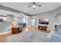 Bright living room with hardwood floors, fireplace, and access to patio at 8725 Red Brook Dr # 104, Las Vegas, NV 89128