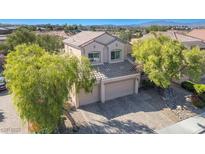 Two-story house with three-car garage, landscaping, and mountain views at 1033 Logan Patrick Dr, Henderson, NV 89052