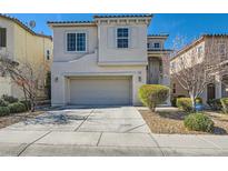 Charming two-story home featuring a two-car garage, landscaped front yard, and inviting curb appeal at 10997 Sardinia Sands Dr, Las Vegas, NV 89141
