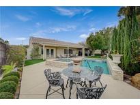 Inviting backyard featuring a pool, spa, outdoor seating, and well-maintained landscaping at 2009 Fern Hill Ct, Henderson, NV 89052
