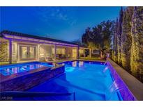 Stunning pool and spa at night with water features at 2009 Fern Hill Ct, Henderson, NV 89052