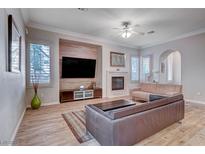 Spacious living room featuring a fireplace and built-in entertainment center at 2428 Granada Bluff Ct, Las Vegas, NV 89135