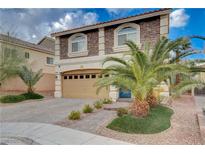 Two-story house with stone accents, a beige garage door, and a landscaped front yard at 6152 Sky River Ct, Las Vegas, NV 89118