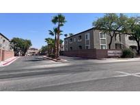 Community entrance with palm trees and building view at 6160 Rumrill St # 113, Las Vegas, NV 89113