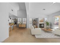 Bright living room boasts high ceilings, fireplace, and seamless flow to the kitchen and outdoor patio at 6175 Rocky Top Ave, Las Vegas, NV 89110