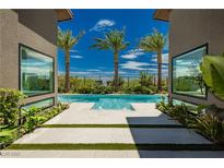 Luxury pool with palm trees and modern architecture at 818 Meyer May St, Las Vegas, NV 89138