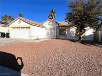 Single-story house with a two-car garage and desert landscaping at 118 Queenswreath Dr, North Las Vegas, NV 89031