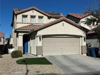 Two-story house with beige exterior, solar panels and a two-car garage at 264 Bella Matese Ave, Las Vegas, NV 89183