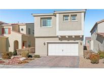 Tan two-story house with a two-car garage and landscaped front yard at 266 Cullerton St, Las Vegas, NV 89148