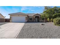 Single-story house with a two-car garage and gravel landscaping at 4911 E Parkwood Dr, Pahrump, NV 89061