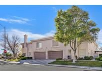 Two-story townhome with a two-car garage and landscaped front yard at 513 Rafkin Pl, Henderson, NV 89052