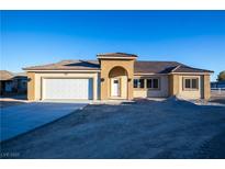 New single-story home with a two-car garage and neutral exterior at 521 Antelope Ave, Pahrump, NV 89060