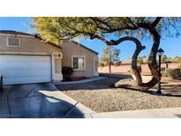 Single-story house with a front yard, driveway, and mature tree at 5633 Bridgehampton Ave, Las Vegas, NV 89130